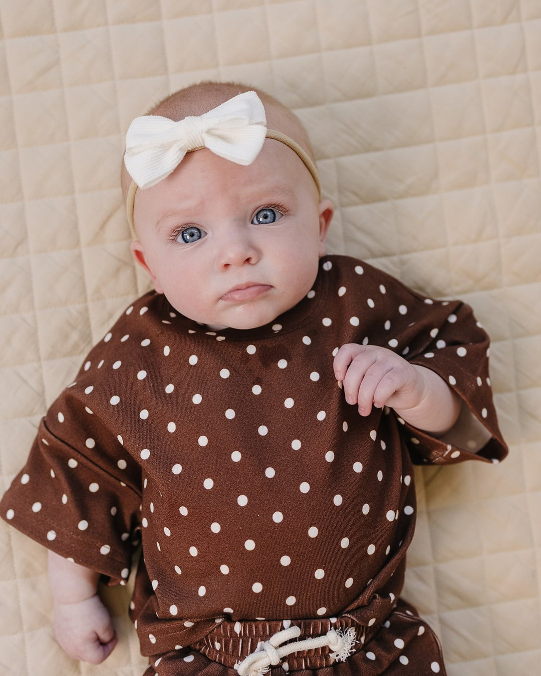 baby girl wearing Lucky Panda Kids Brown Polka Shorts Set — brown and white polka dot cotton two-piece outfit