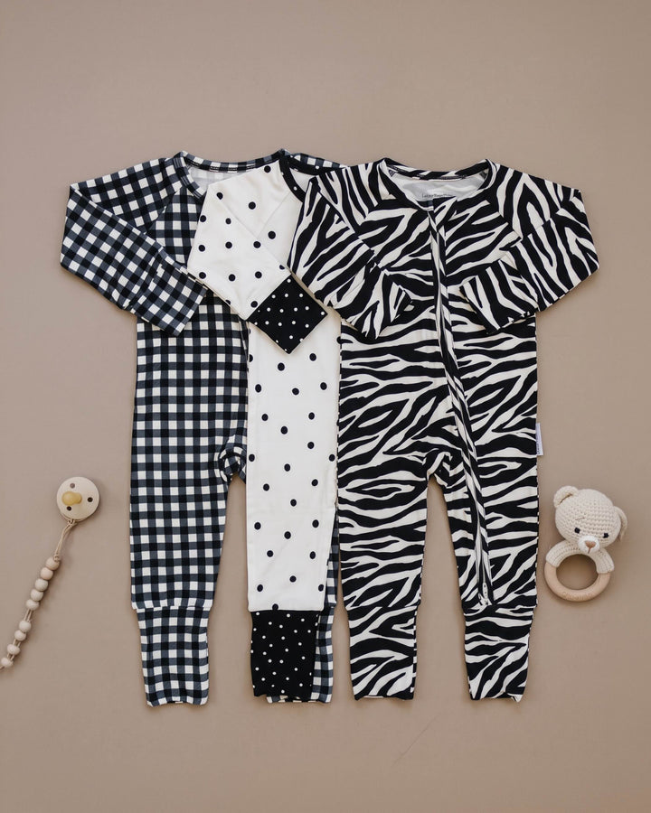 Classic Polka, Black Gingham, and Zebra bamboo zip rompers shown together