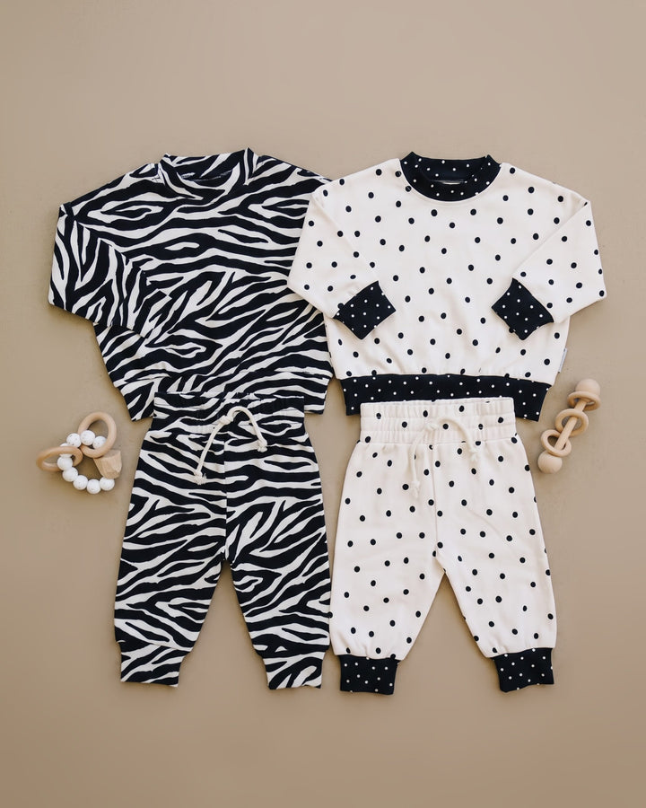 Zebra and Classic Polka Lucky Panda Kids outfits shown in a coordinating flat lay