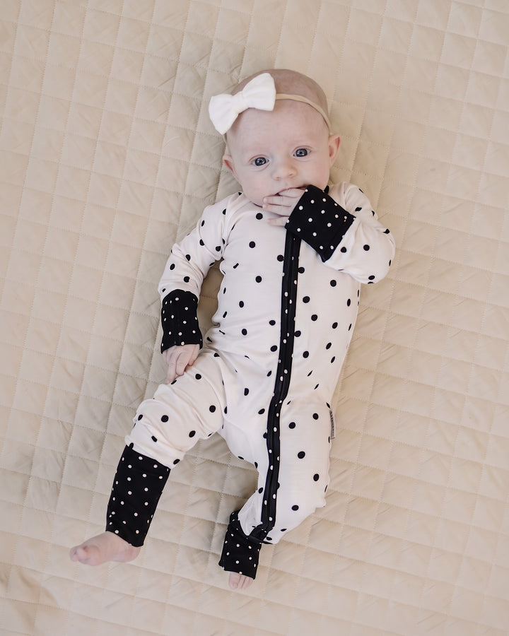 Baby relaxing in the Classic Polka Bamboo Zip Romper