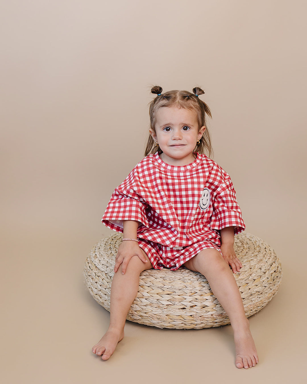 Baby wearing Lucky Panda Kids Red Gingham Shorts Set — gender neutral cotton two-piece with smiley face patch
Lucky Panda Kids Shorts Set Red Gingham flat lay — relaxed top with smiley patch and matching elastic waistband shorts
Toddler in Lucky Panda Kids Red Gingham Shorts Set — sizes 0–3M to 8–9Y, gender neutral summer outfit
Close-up of Lucky Panda Kids Red Gingham Shorts Set smiley face patch — soft 95% cotton kids two-piece
Lucky Panda Kids Red Gingham Shorts Set on baby — gender neutral cotton summer