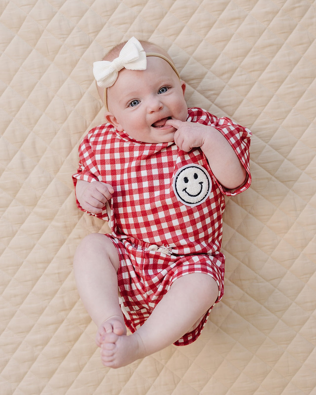 Baby wearing Lucky Panda Kids Red Gingham Shorts Set — gender neutral cotton two-piece with smiley face patch
Lucky Panda Kids Shorts Set Red Gingham flat lay — relaxed top with smiley patch and matching elastic waistband shorts
Toddler in Lucky Panda Kids Red Gingham Shorts Set — sizes 0–3M to 8–9Y, gender neutral summer outfit
Close-up of Lucky Panda Kids Red Gingham Shorts Set smiley face patch — soft 95% cotton kids two-piece
Lucky Panda Kids Red Gingham Shorts Set on baby — gender neutral cotton summer
