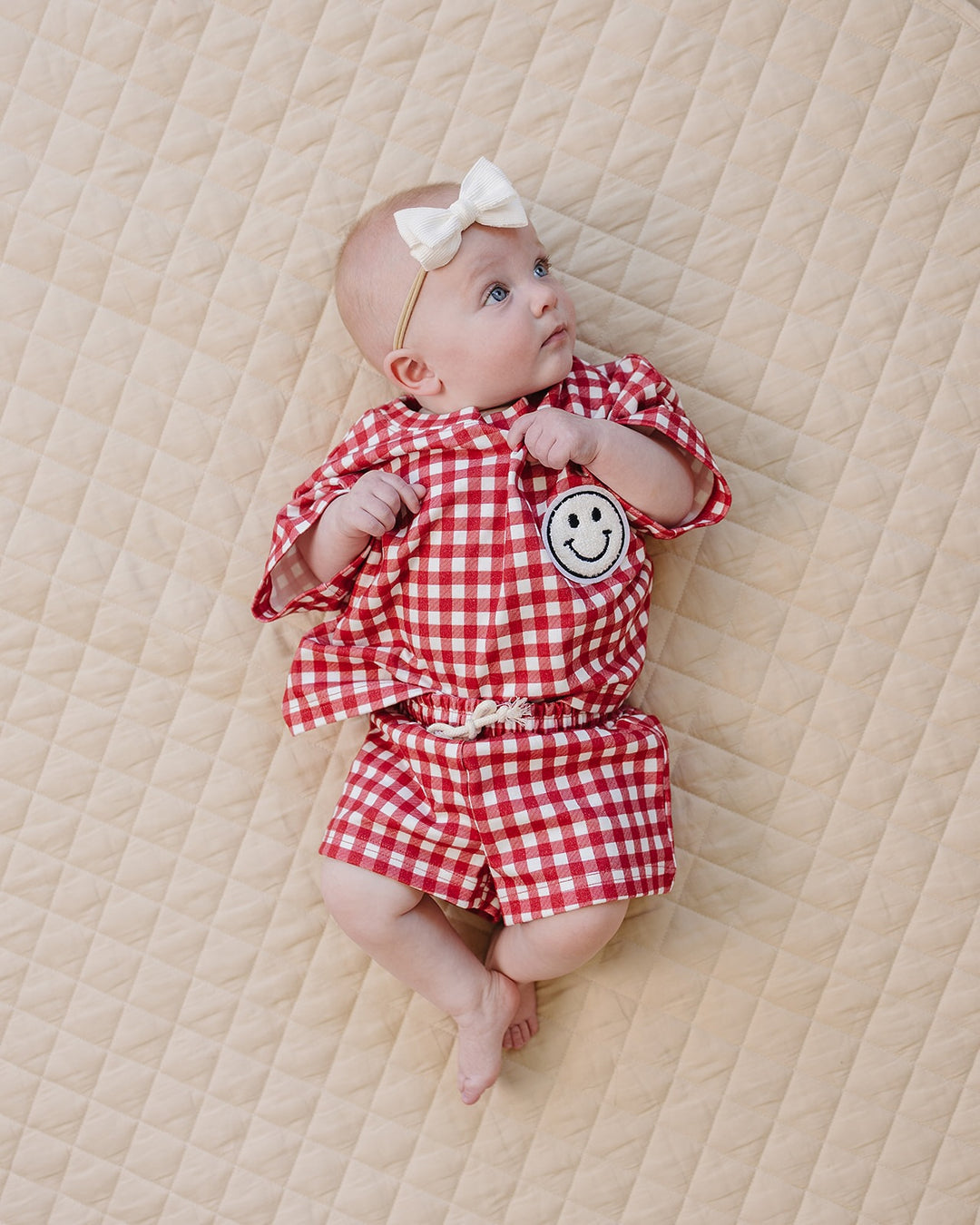 Baby wearing Lucky Panda Kids Red Gingham Shorts Set — gender neutral cotton two-piece with smiley face patch
Lucky Panda Kids Shorts Set Red Gingham flat lay — relaxed top with smiley patch and matching elastic waistband shorts
Toddler in Lucky Panda Kids Red Gingham Shorts Set — sizes 0–3M to 8–9Y, gender neutral summer outfit
Close-up of Lucky Panda Kids Red Gingham Shorts Set smiley face patch — soft 95% cotton kids two-piece
Lucky Panda Kids Red Gingham Shorts Set on baby — gender neutral cotton summer
